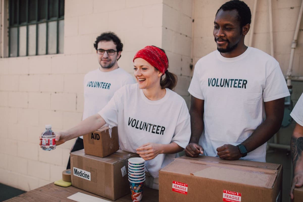 Volunteers sorting donated food into boxes